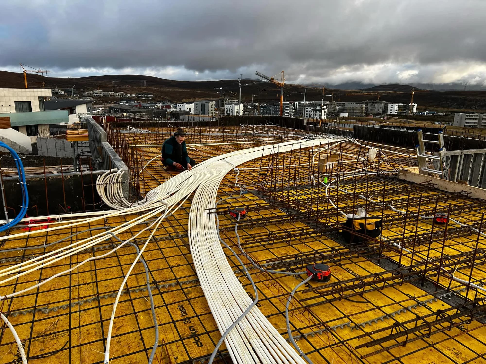 Conduits laid across a floor slab on a building site