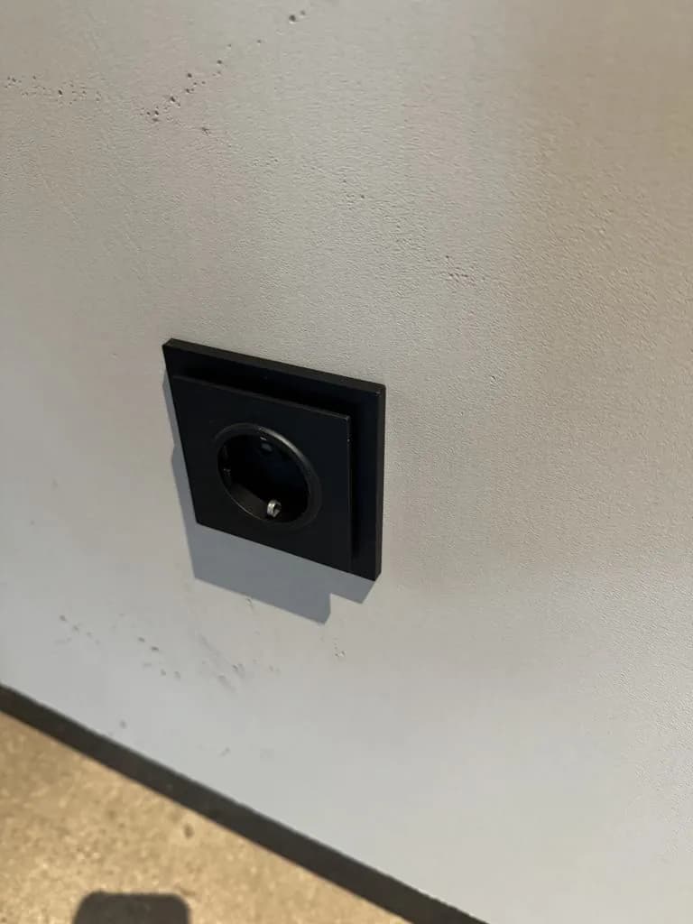 Wall socket in a black frame