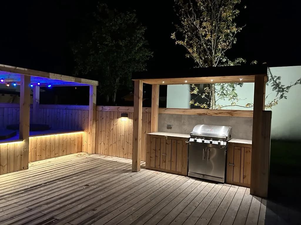 Deck with an outdoor kitchen and lighting