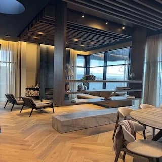Lounge with lighting in a timber-slat ceiling